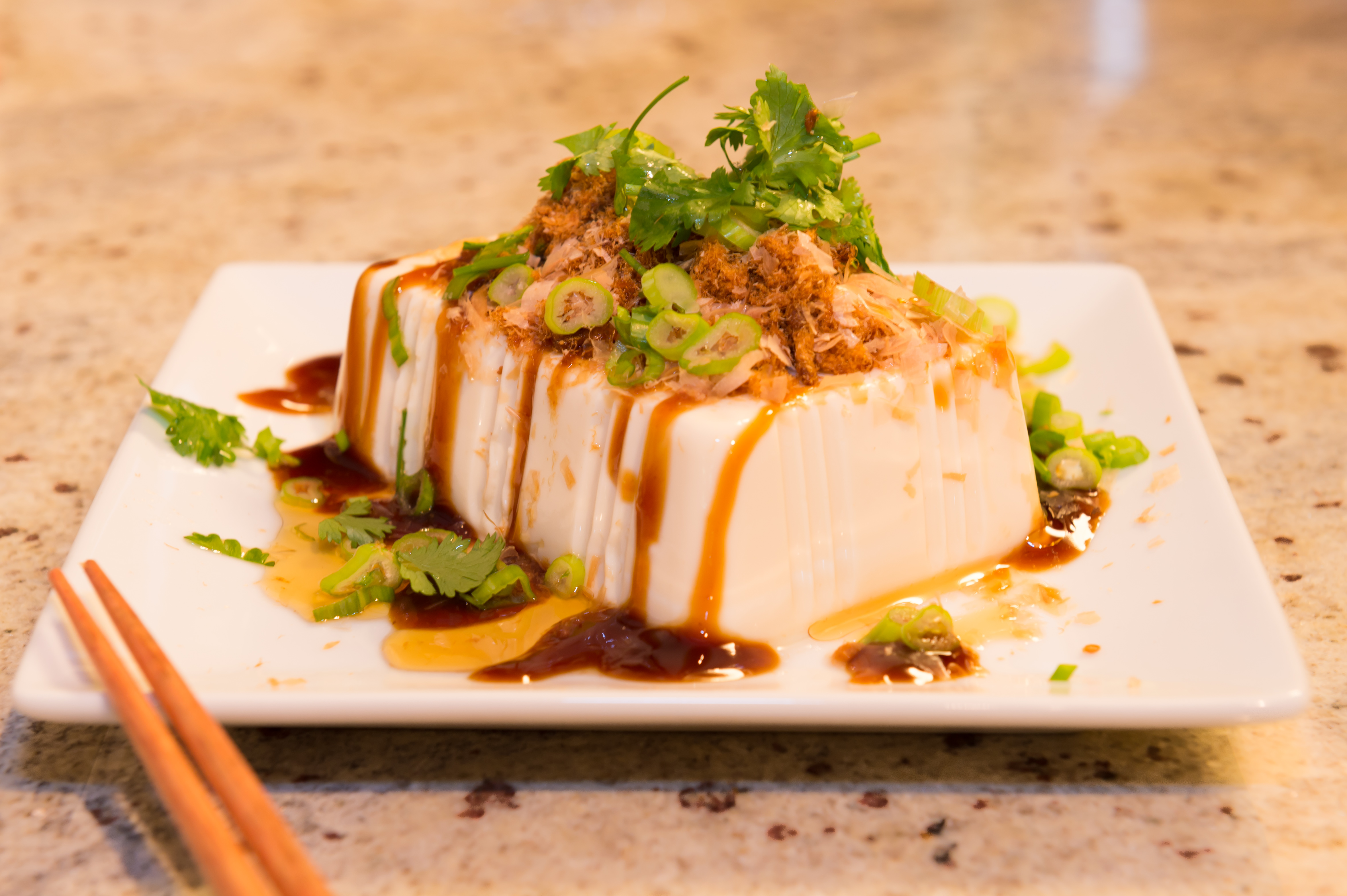 Cold tofu top with spring onions/cilantro bonito flakes and soy paste.